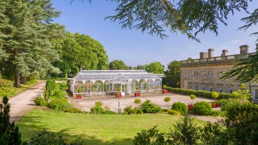 The exterior of the conservatory and house at Wentworth Castle Gardens on a sunny day